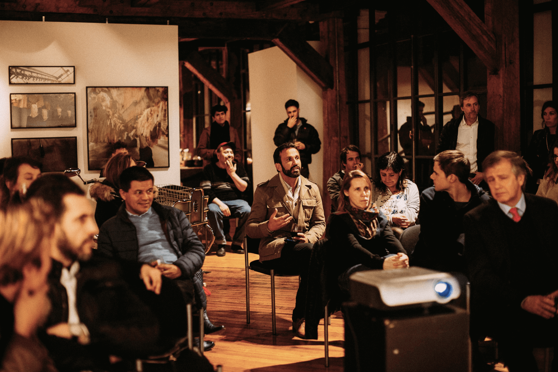 A crowd of people sitting in the audience of an event.