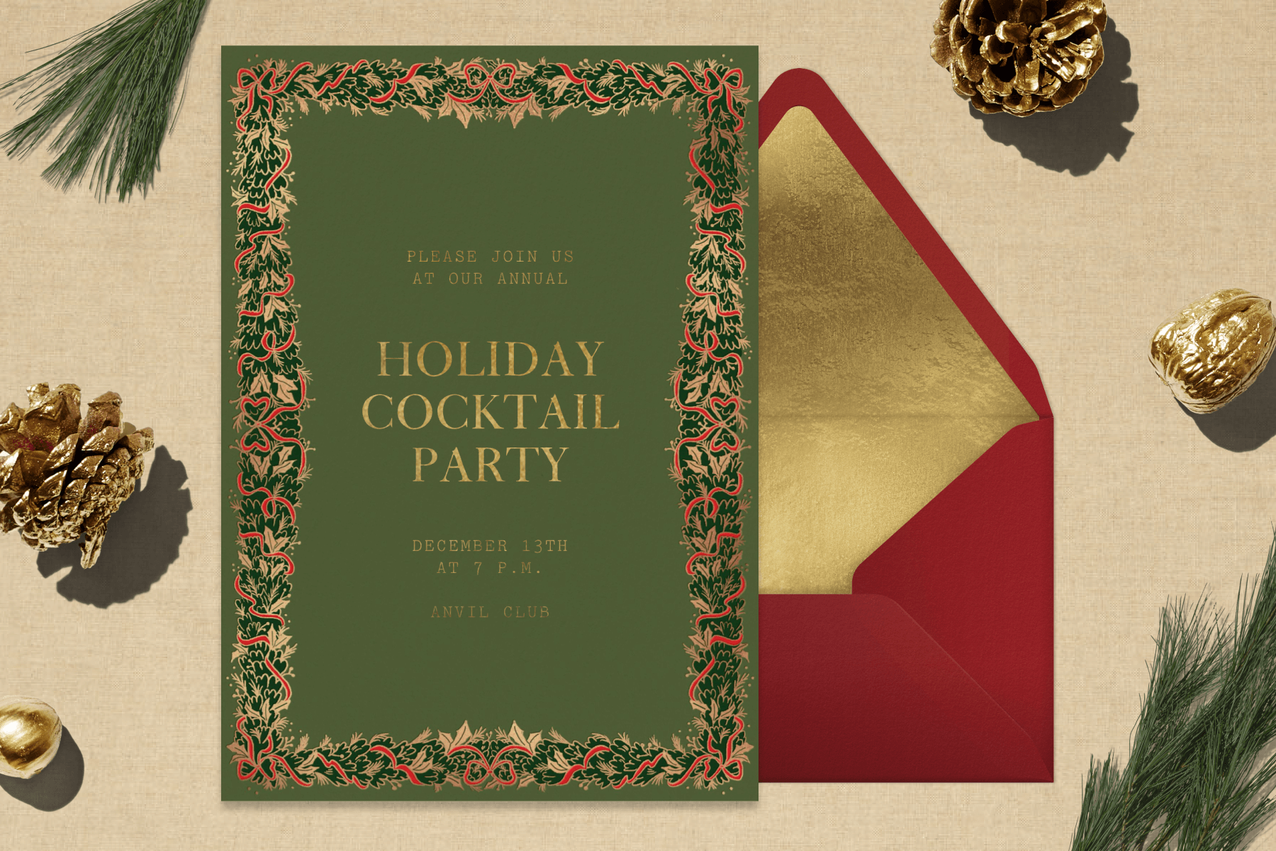 An olive green holiday cocktail party invitation with a garland border in front of a red and gold envelope, over a backdrop with gold ornaments and greenery.