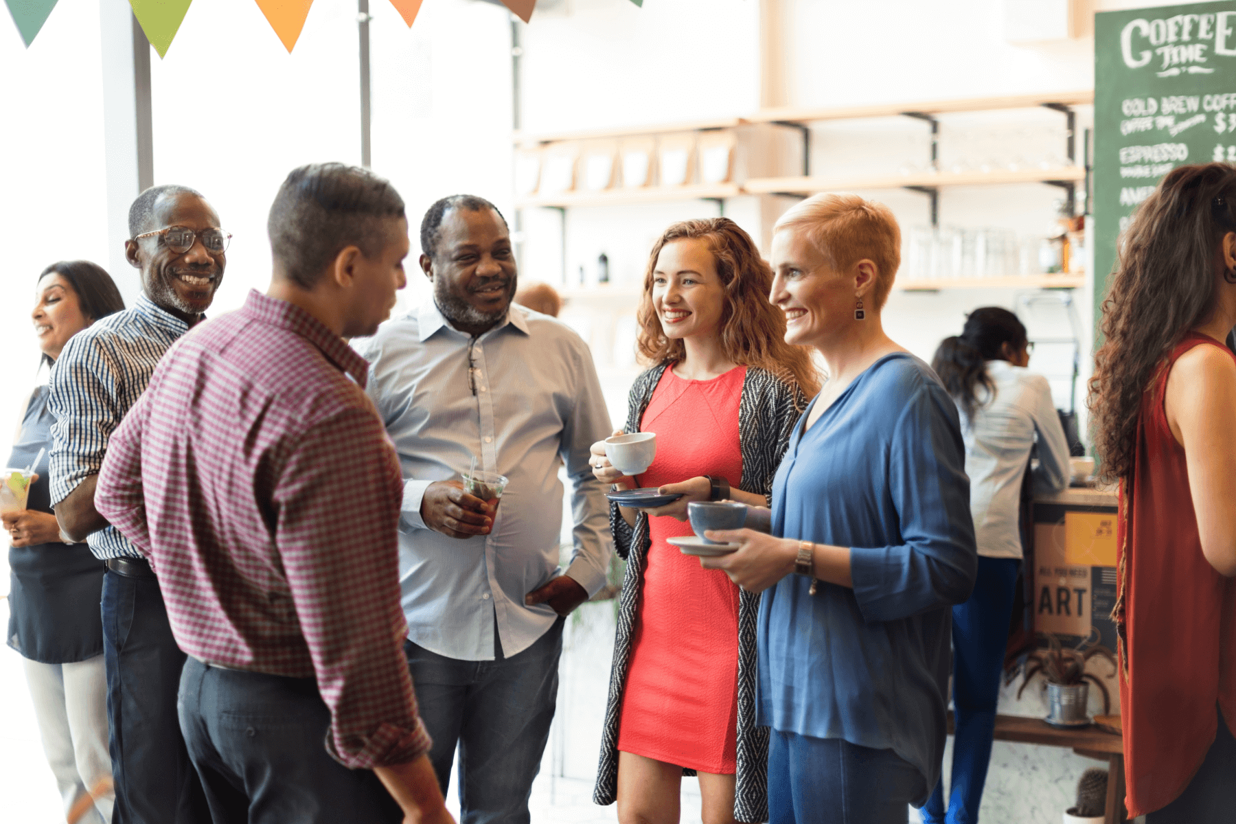 A group of people sipping coffee and drinks together at an event.