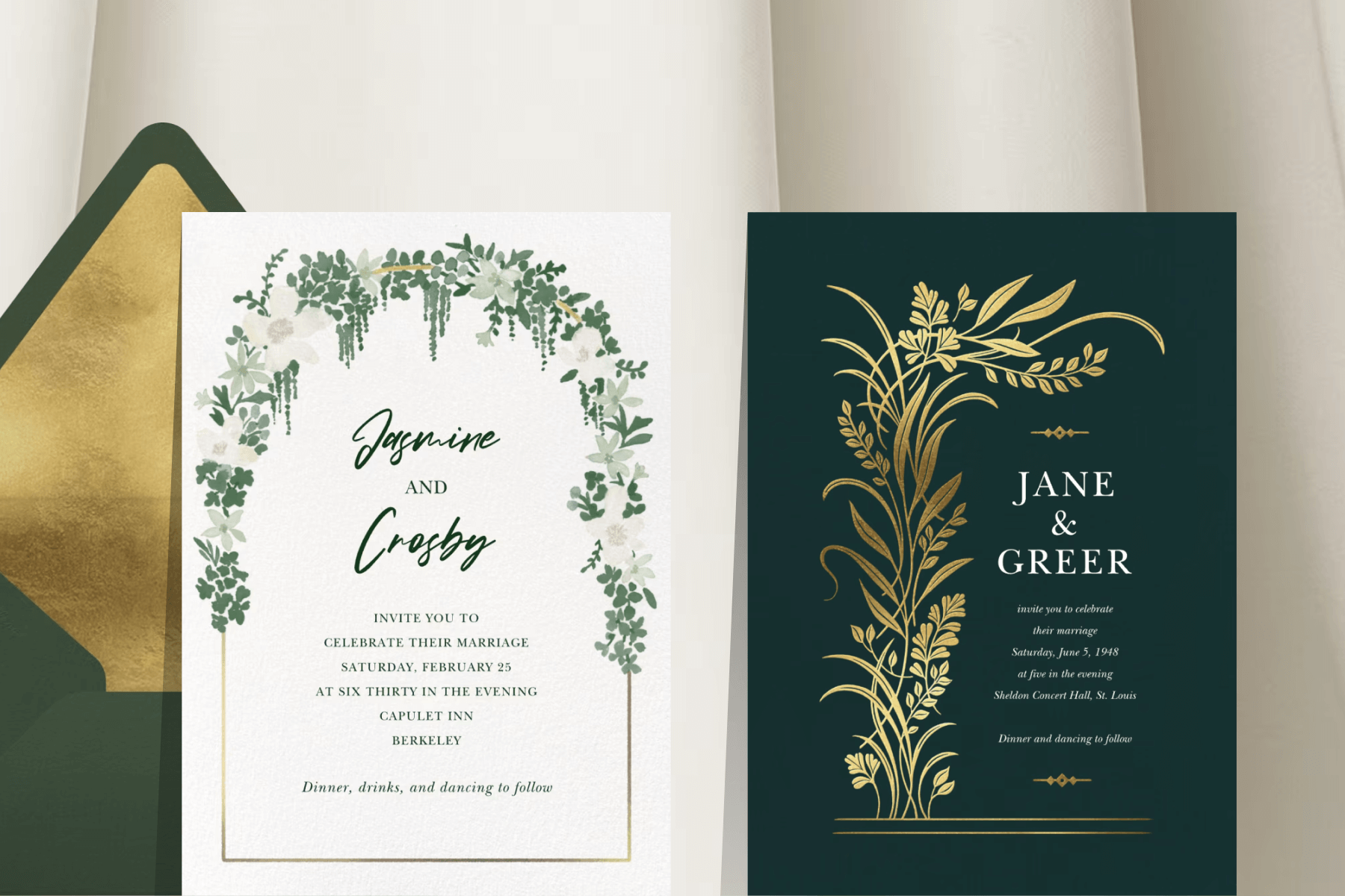 A white wedding invitation with a gold arch covered in green watercolor florals; A dark green wedding invitation with gold leaves and white lettering. 