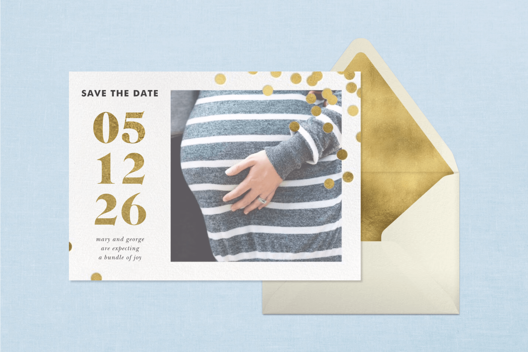 A pregnancy announcement card with a photo of a pregnant belly along with gold numbers indicating the due date and gold confetti in front of a light blue backdrop. 