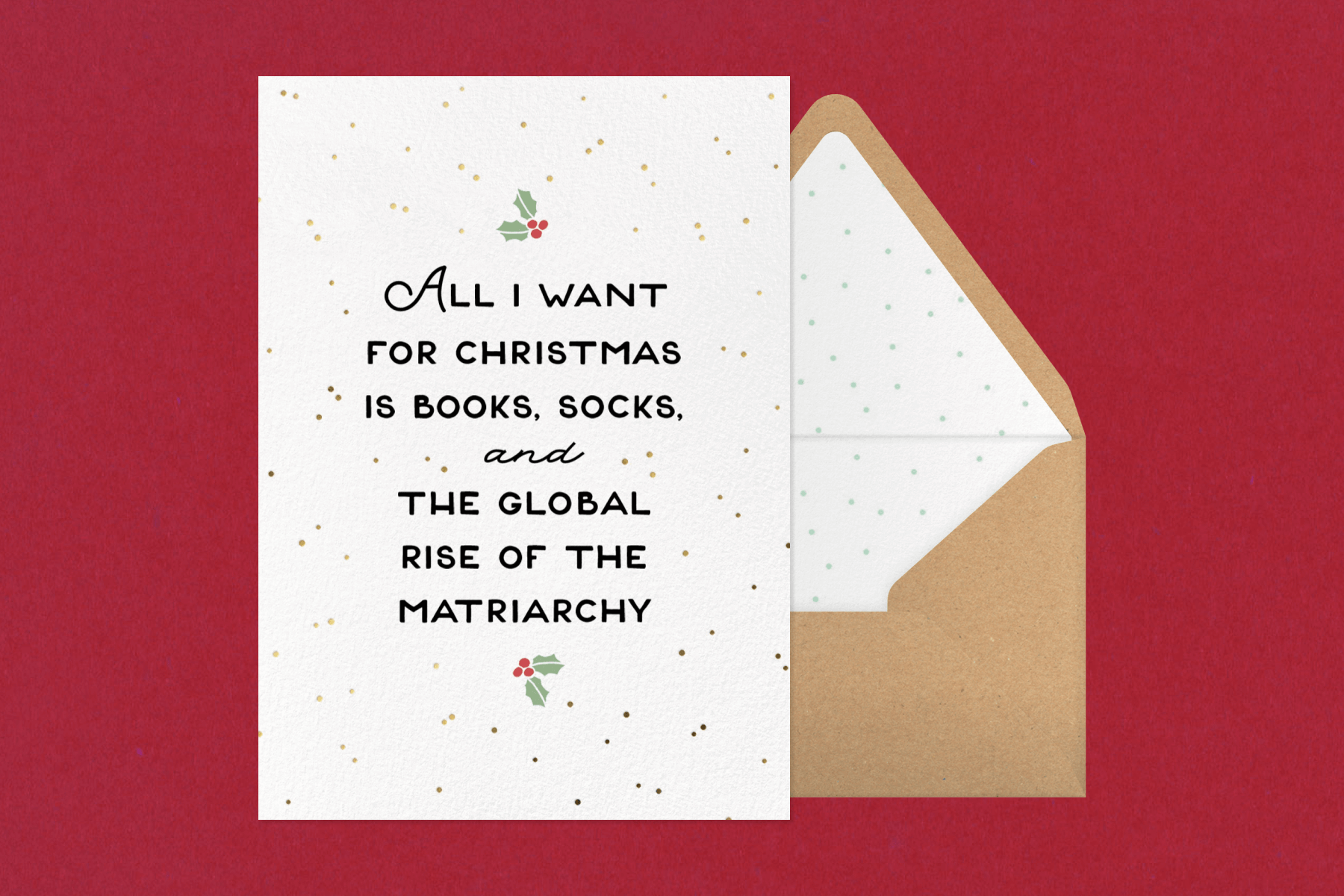 A white card with black text reading ‘ALL I WANT FOR CHRISTMAS IS BOOKS, SOCKS, AND THE GLOBAL RISE OF THE MATRIARCHY’. 