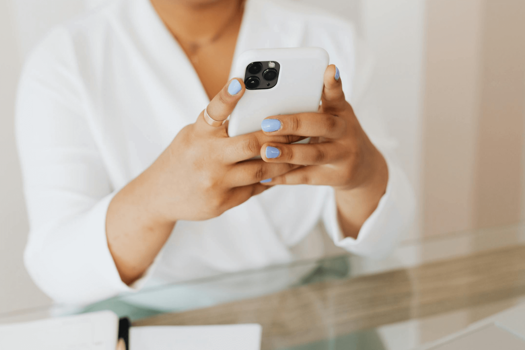 A woman’s hands holding a smartphone. 