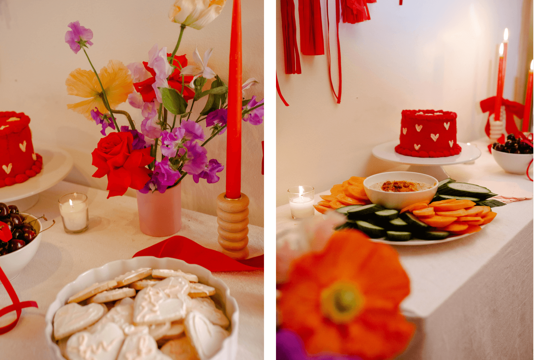 A table with colorful flowers, red candles, a bowl of cherries, and a bowl of heart-shaped cookies; A table with a red cake with white hearts and a tray of vegetables and dip. 