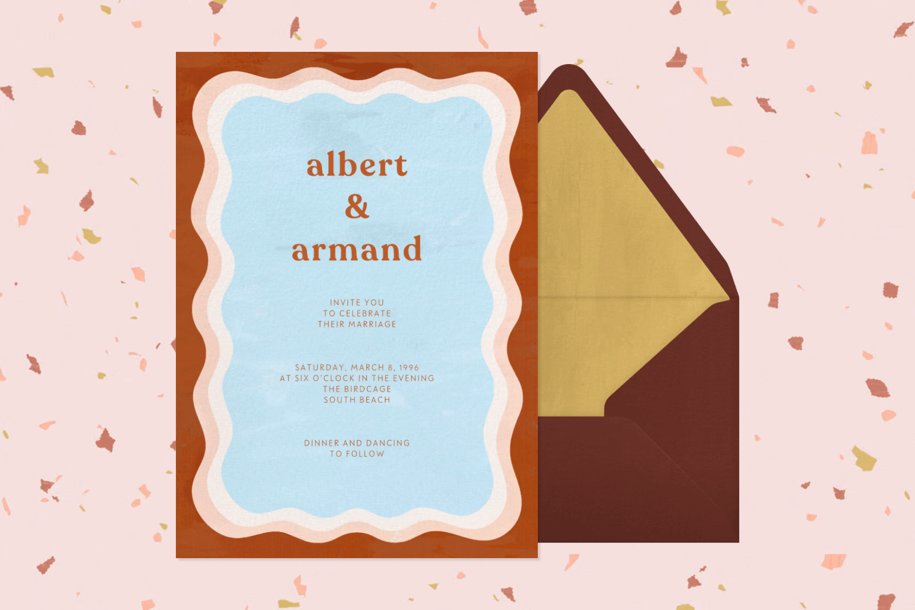 A blue wedding invitation with brown text and a brown and pink wavy-lined border in front of a brown and gold envelope.