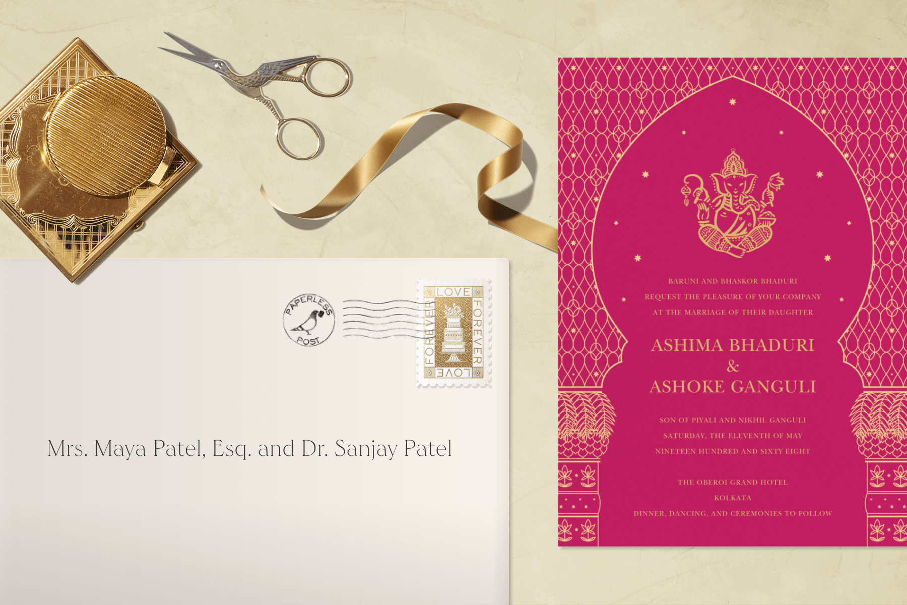 An Indian wedding invitation, envelope, and gold ribbon with scissors.