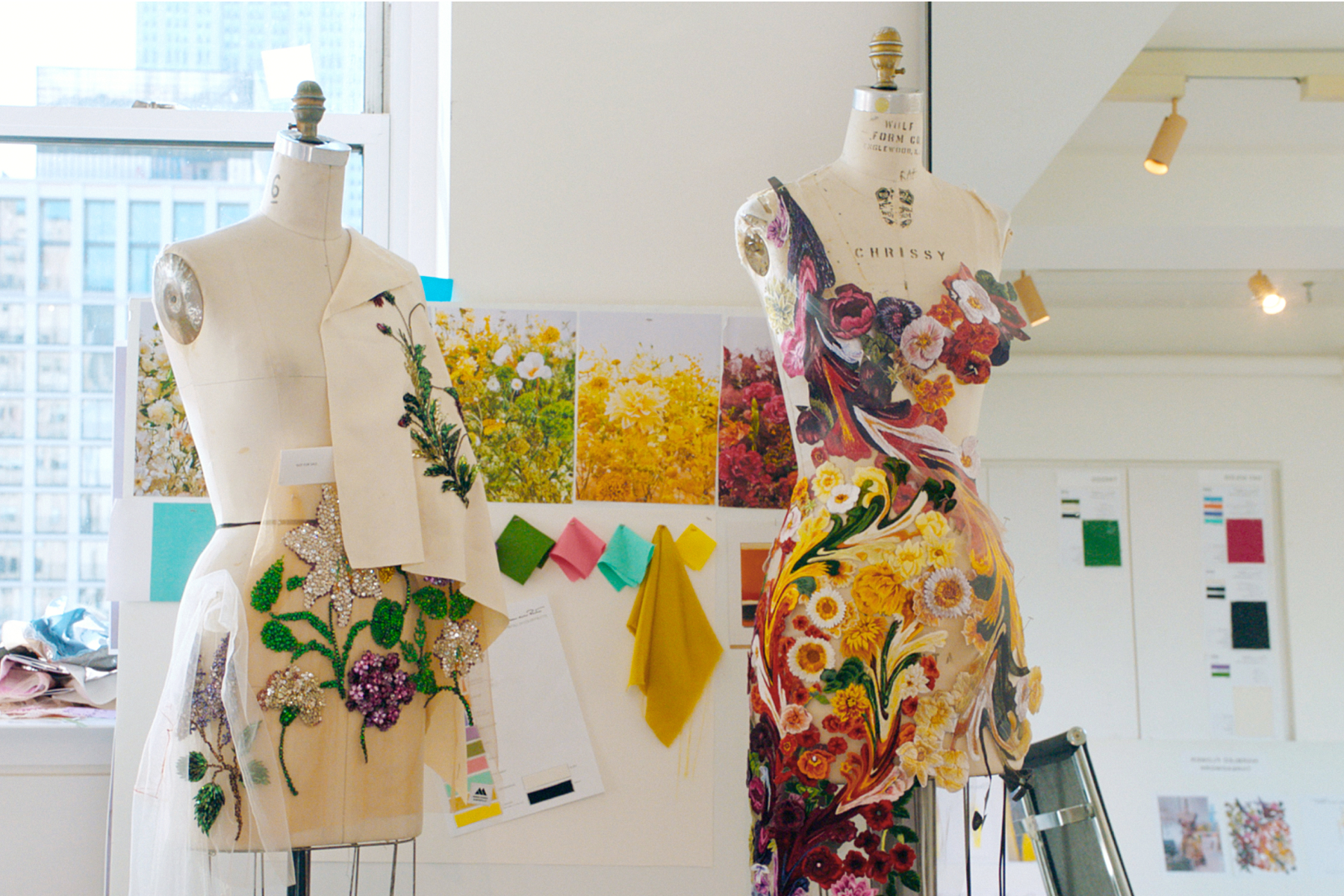 Two mannequin torsos with floral and marbleized designs in the process of being created. 