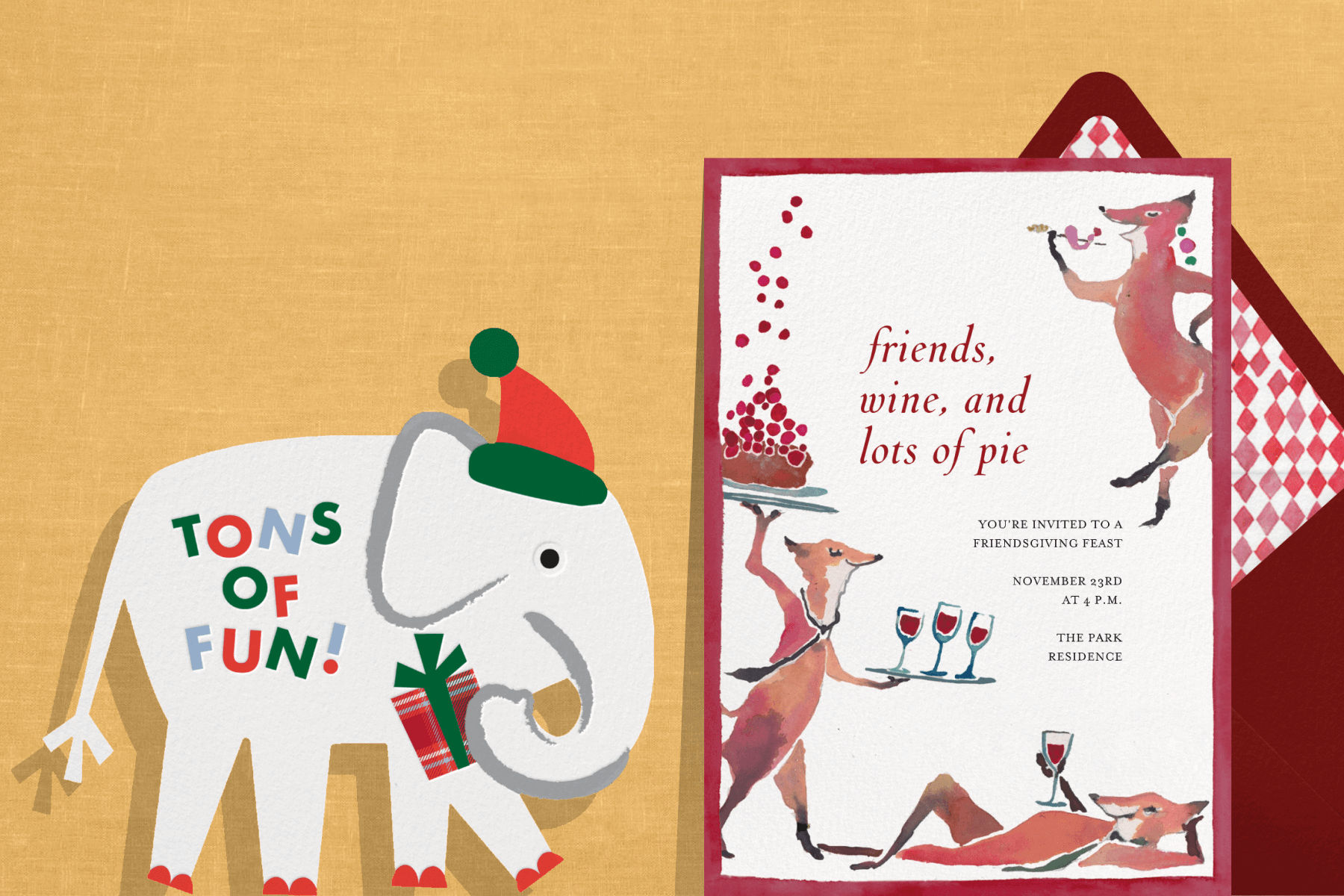 An invitation in the shape of an elephant with text reading ‘TONS OF FUN!’ and an invitation featuring foxes holding food and wine with text reading ‘FRIENDS, WINE, AND LOTS OF PIE’.