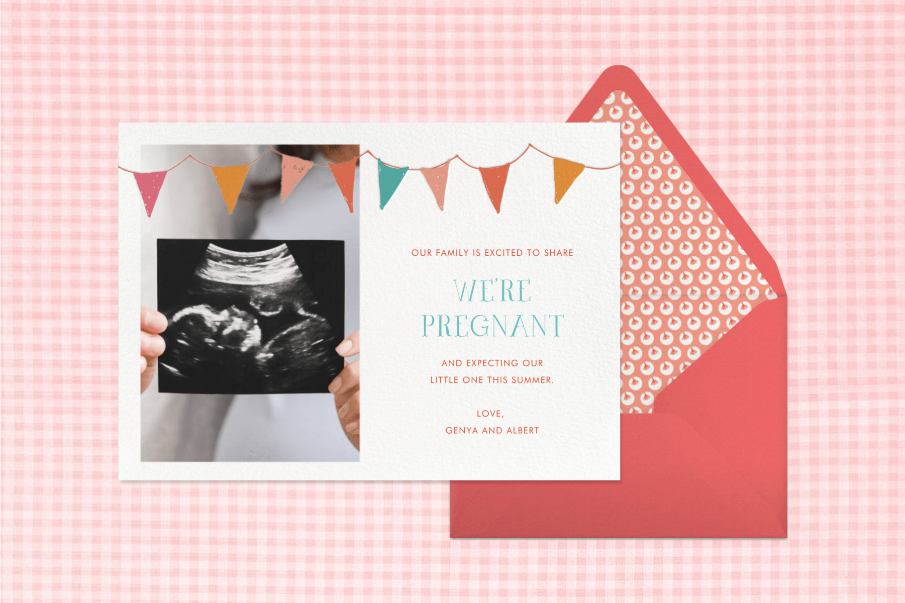 A pregnancy announcement card with a photo of an ultrasound image next to a red envelope and in front of a pink gingham backdrop.