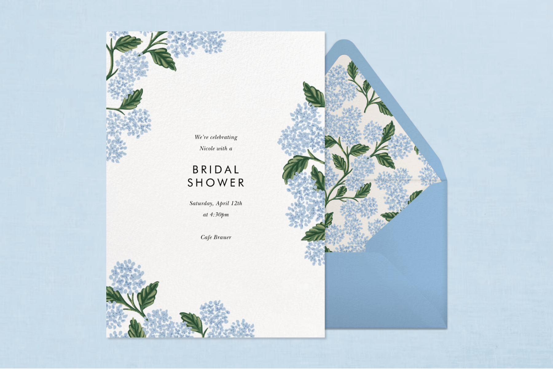 A white bridal shower invitation with light blue florals