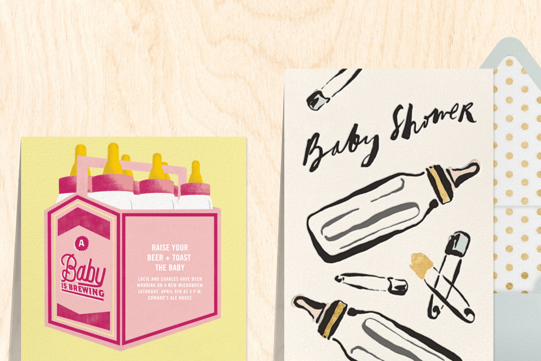 An invitation with a six-pack of baby bottles; An invitation with illustrations of baby bottles and diaper pins.