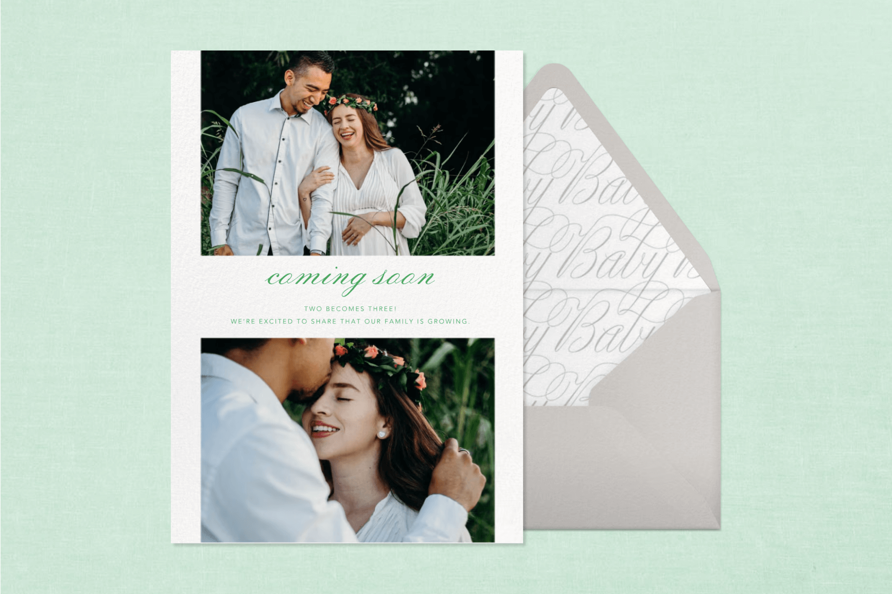 A pregnancy announcement card with two photos of a couple and cursive text reading ‘COMING SOON’ next to a grey envelope and in front of a teal backdrop.