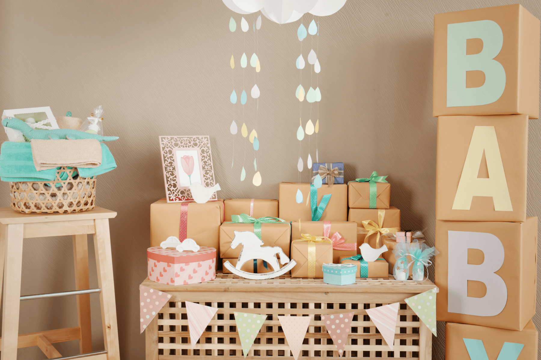 A gift table at a baby shower surrounded by decorations.