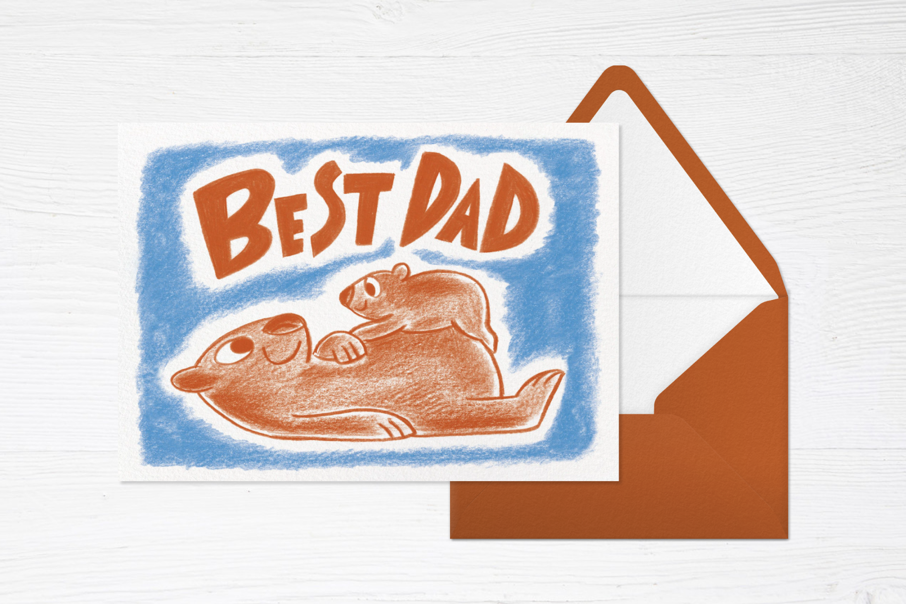 A Father’s Day card that reads ‘Best Dad’ with an illustration of a baby bear on a papa bear’s tummy next to a brown envelope.